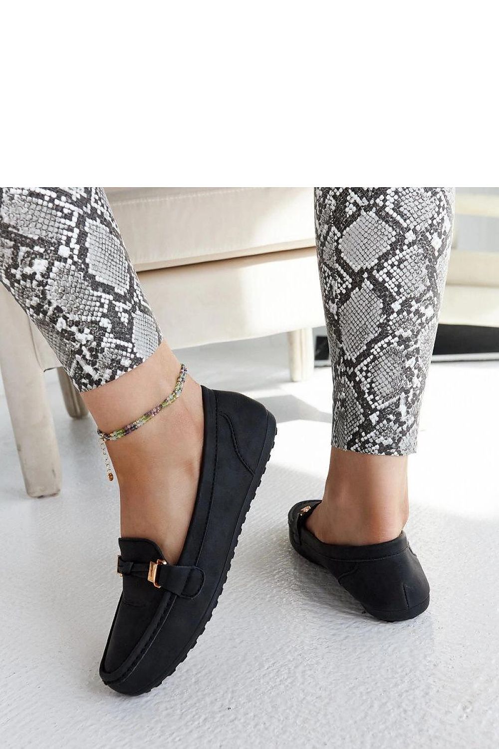 Showcasing Solea's luxury black Scafati moccasins for women in an outdoor setting, ideal for warm summer days with fashionable comfort.