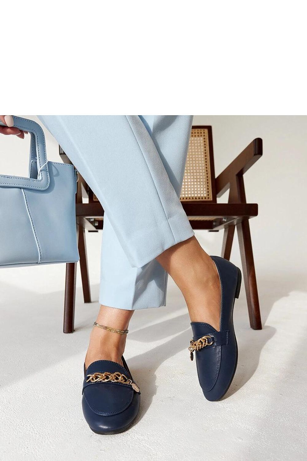 Solea stylish navy blue moccasins displayed against a minimalist backdrop, emphasizing their elegant design suitable for both casual and formal occasions.