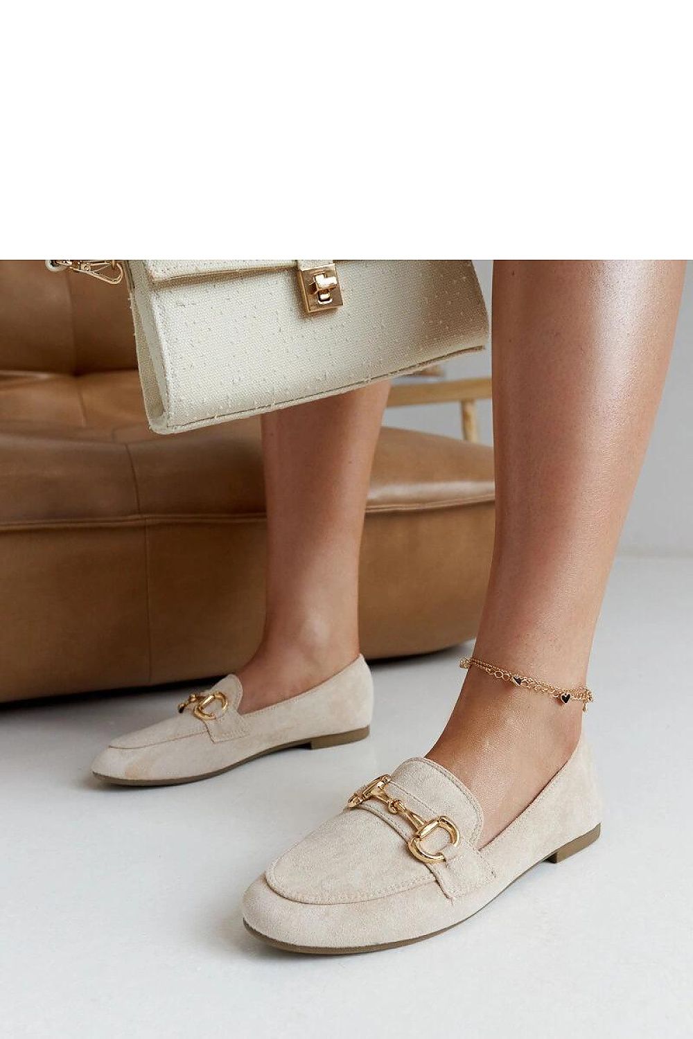 Close-up of Solea eco leather beige loafers showcasing decorative buckle detail, ideal for adding a touch of sophistication to your wardrobe.