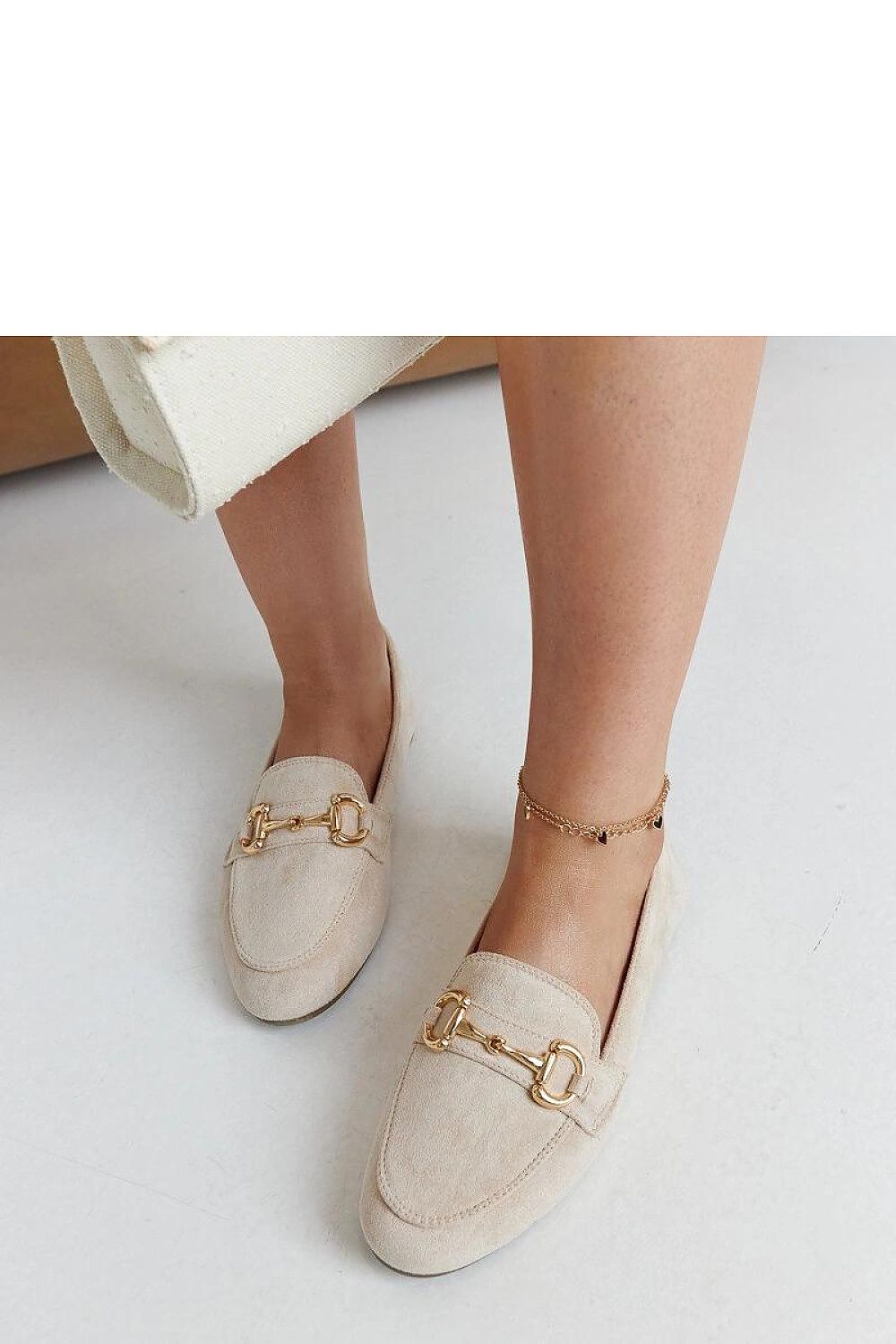 Solea fashionable beige loafers in various sizes, designed for comfort and elegance with a slip-on style and chic buckle accent.