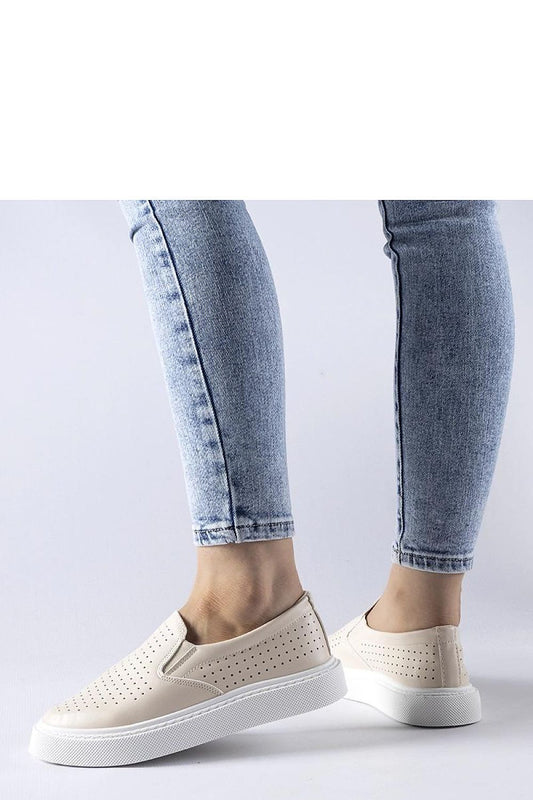 Close-up of Solea luxury beige perforated sneakers, highlighting the detailed craftsmanship and breathable material, perfect for warm days.