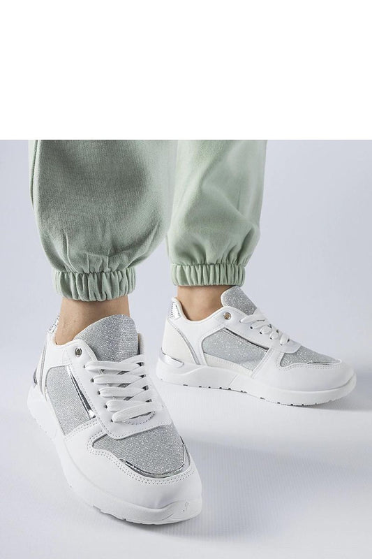 Luxury white sneakers designed by Solea, featuring decorative stitching and a lace-up closure for a perfect fit, ideal for spring and summer wear.