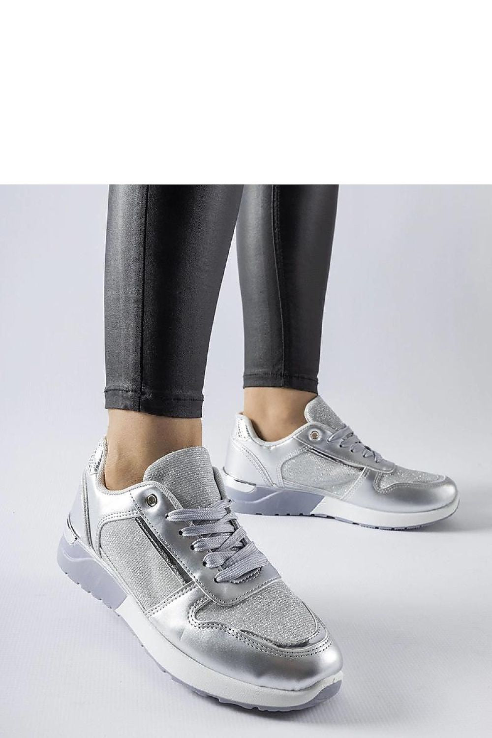 Fashionable Solea white sneakers on a stylish background, ideal for casual wear during warm seasons.