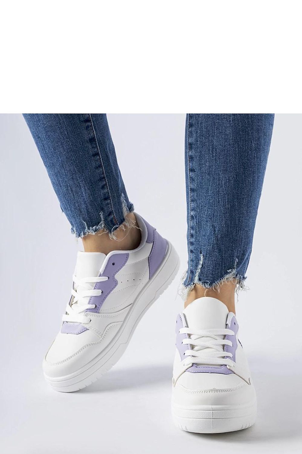 Close-up of Solea's luxurious white sneakers with purple detailing, crafted from eco-friendly synthetic suede leather.