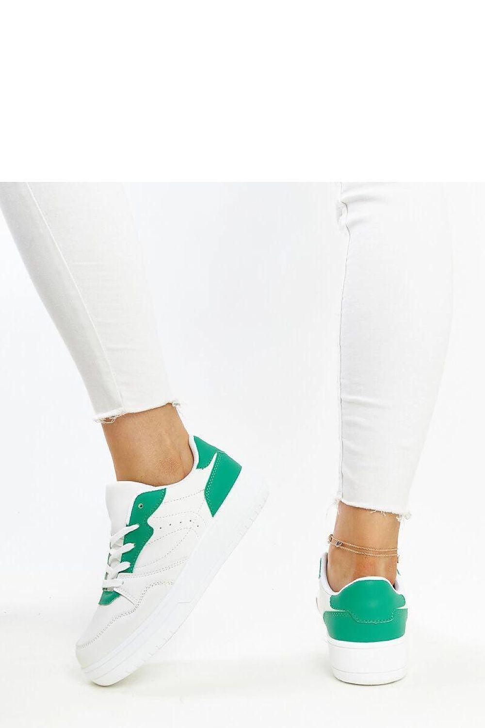 Solea's exquisite white sneakers featuring a trendy purple accent, with a rubber sole for breathability and comfort.