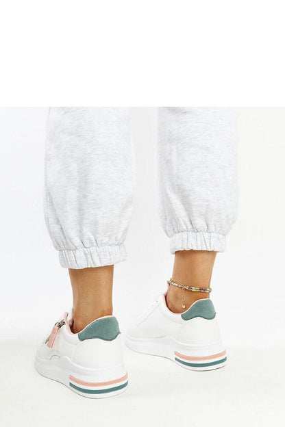 Side profile of Solea's luxurious white sneakers featuring a comfortable rubber sole and laced closure for a perfect fit.