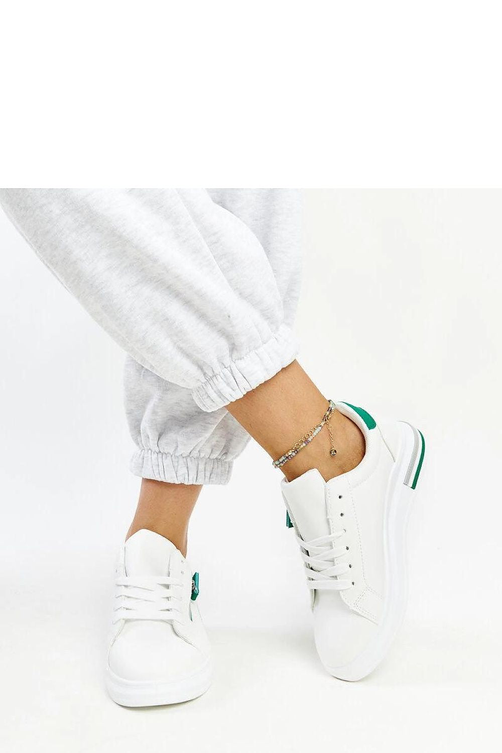 Solea eco-friendly white sneakers displayed on a chic background, highlighting their stylish design and sustainable materials.