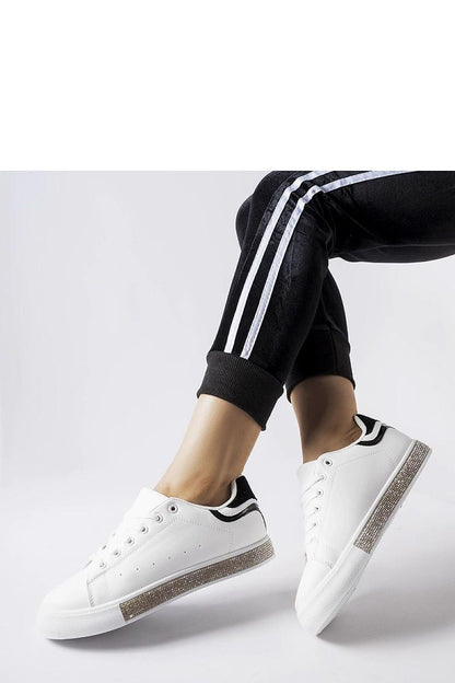 Close-up of Solea black and white sneakers adorned with zircons, highlighting their luxurious quality and fashionable appeal.