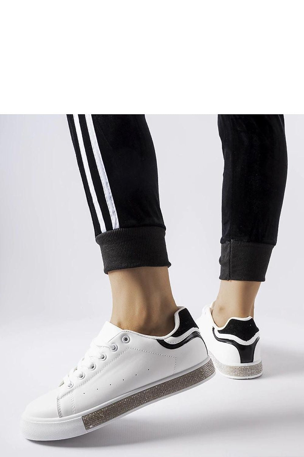 Solea eco-leather black and white sneakers featuring a low cut and round toe, designed for comfort and elegance in everyday fashion.