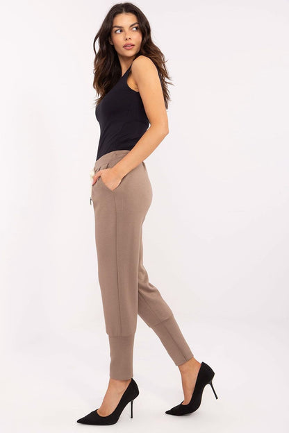 Detailed view of Italy Moda women's high waist tracksuit trousers showcasing the smooth fabric and sporty wide cuffs for a chic appearance.