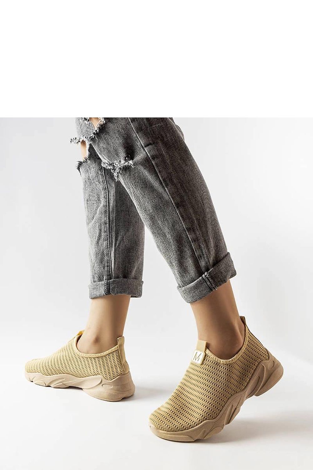 Close-up of Solea dark beige slip-on sports shoes highlighting the durable rubber sole and low profile, designed for comfort and stability.