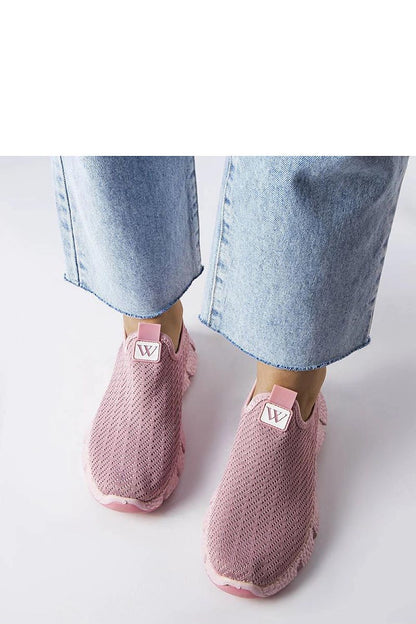 Solea women's pink slip-on sneakers displayed against a summer backdrop, ideal for chic casual outings.