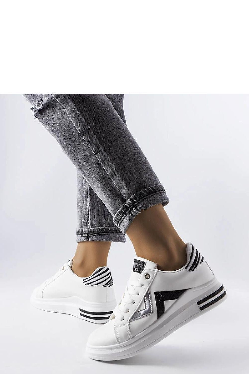 Lifestyle image of Solea women's white and black platform sneakers styled with summer outfits, exemplifying comfort and chic elegance.