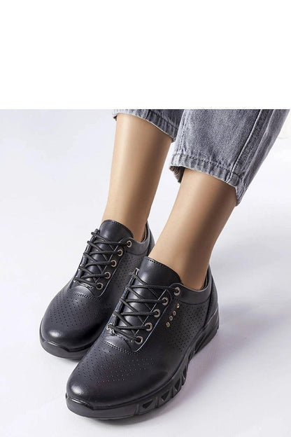 Close-up of Solea black leather cut-out sneakers, highlighting the natural leather quality and summer versatility.