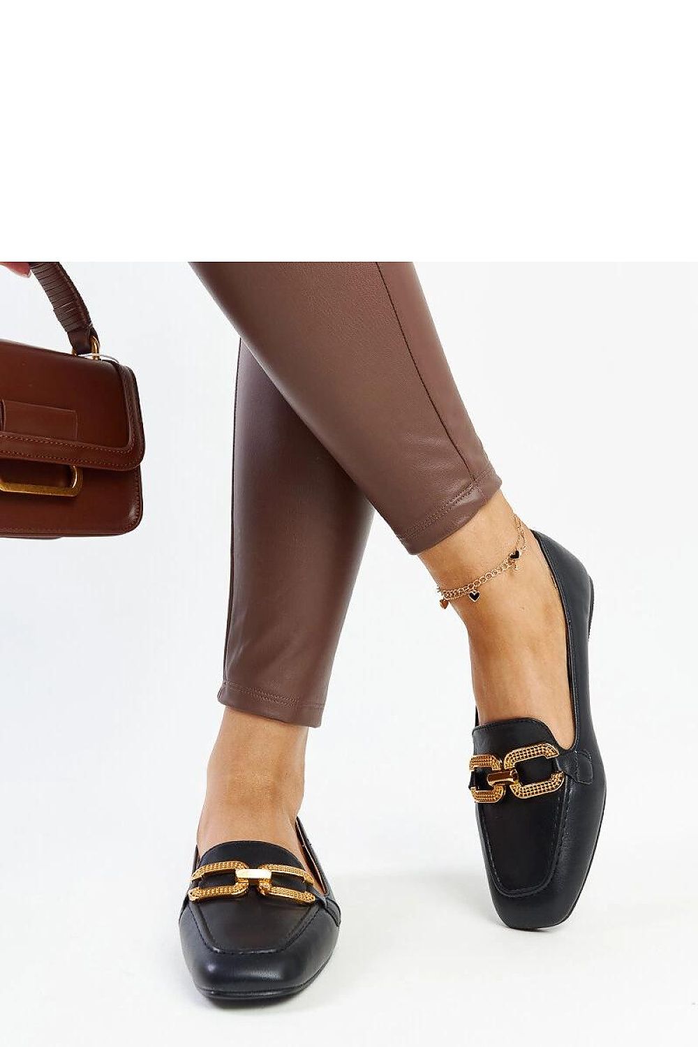 Flat lay image of luxury black eco leather moccasins by Solea, highlighting their rounded toe and sleek design.