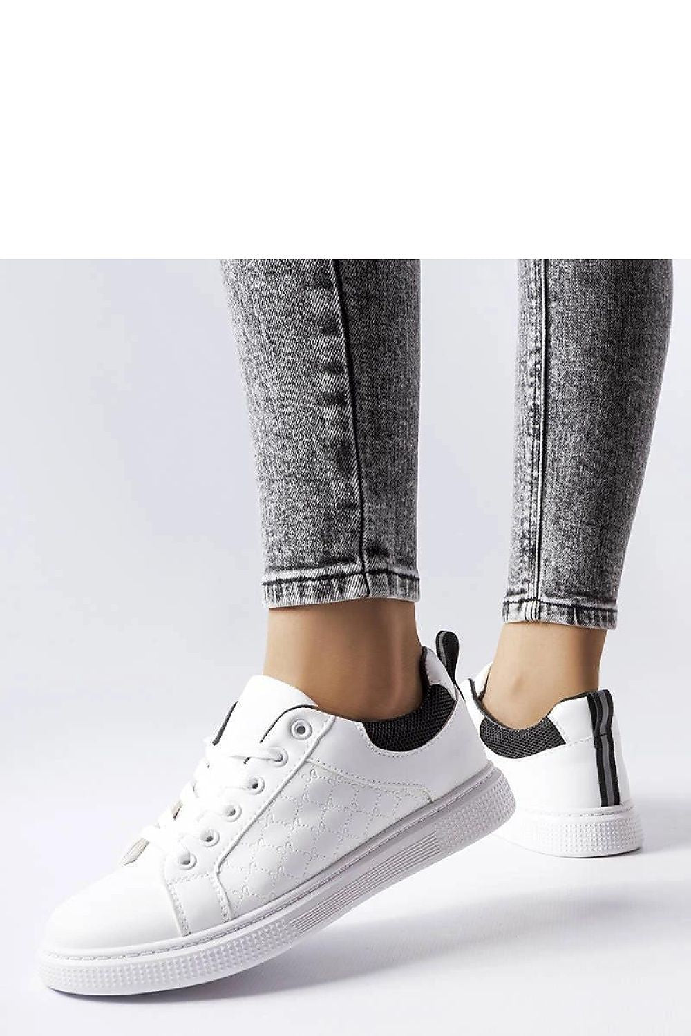 Elegant Solea black sneakers with white rubber soles and unique embossing, ideal for stylish summer outings.