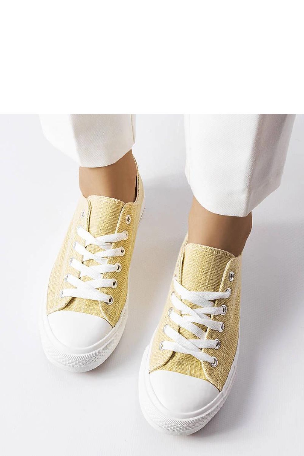 Solea Golden Shiny Sneakers Vignette displayed elegantly on a textured surface, highlighting their chic design suitable for shorts and dresses.