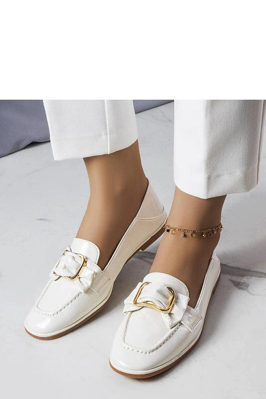 Close-up view of Erica White patent moccasins by Solea, showcasing exquisite buckle and chain accents, perfect for chic summer outfits.
