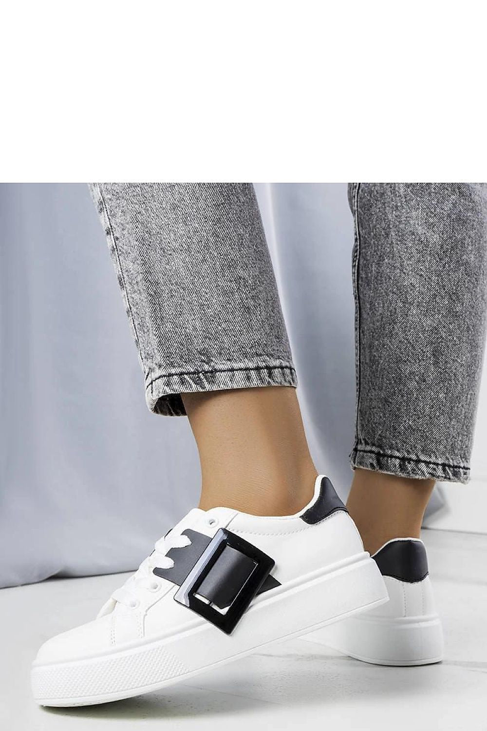 Solea's luxury white sneakers with a stylish pink buckle, ideal for adding a touch of sophistication to summer attire.