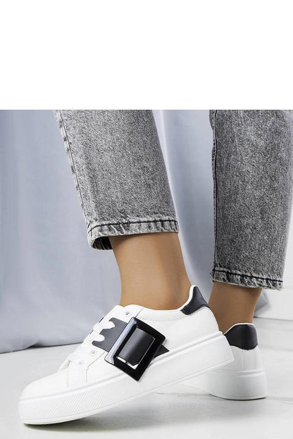 Solea's luxury white sneakers with a stylish pink buckle, ideal for adding a touch of sophistication to summer attire.