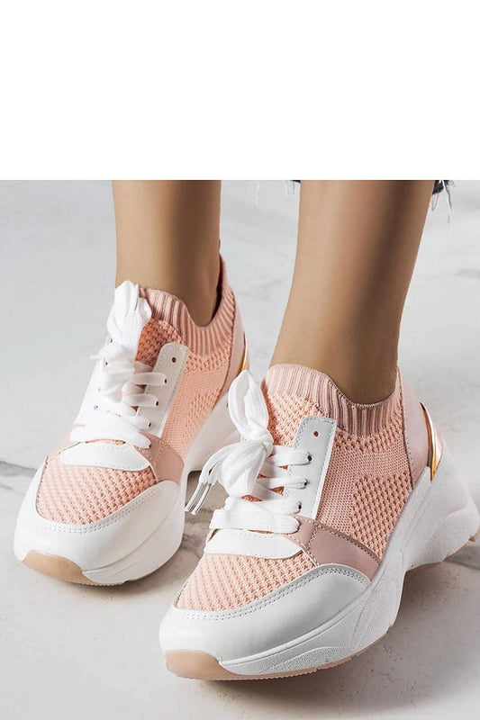 Close-up of Solea's pink wedge sneakers, featuring a white rubber sole for stability, perfect for summer outings and a luxurious casual look.