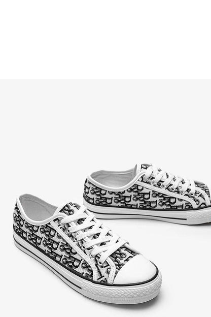 Elegant flat lay of Solea Rimmie women's sneakers in black and white, showcasing the seamless blend of luxury and contemporary style.