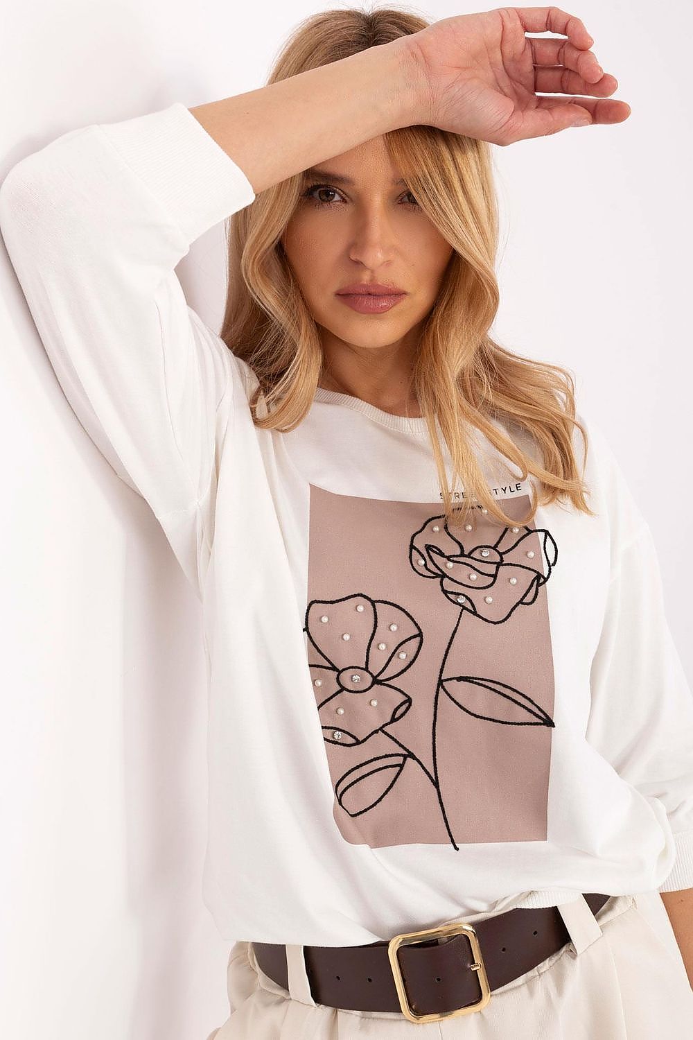 Overall outfit presentation featuring the Relevance casual blouse with pearls and embroidery, suitable for any elegant gathering.