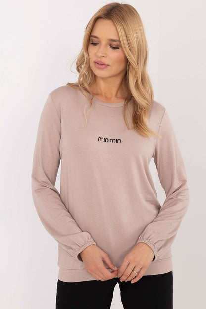 Model wearing the long sleeve micro modal blouse from Relevance, styled for an elegant and casual look, perfect for everyday outings.