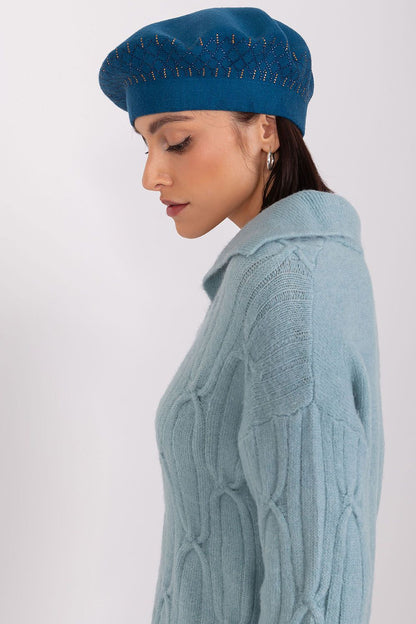 Flat lay of the stylish beret hat by AT, design emphasizing its blend of acrylic, cotton, and cashmere for a fashionable look.