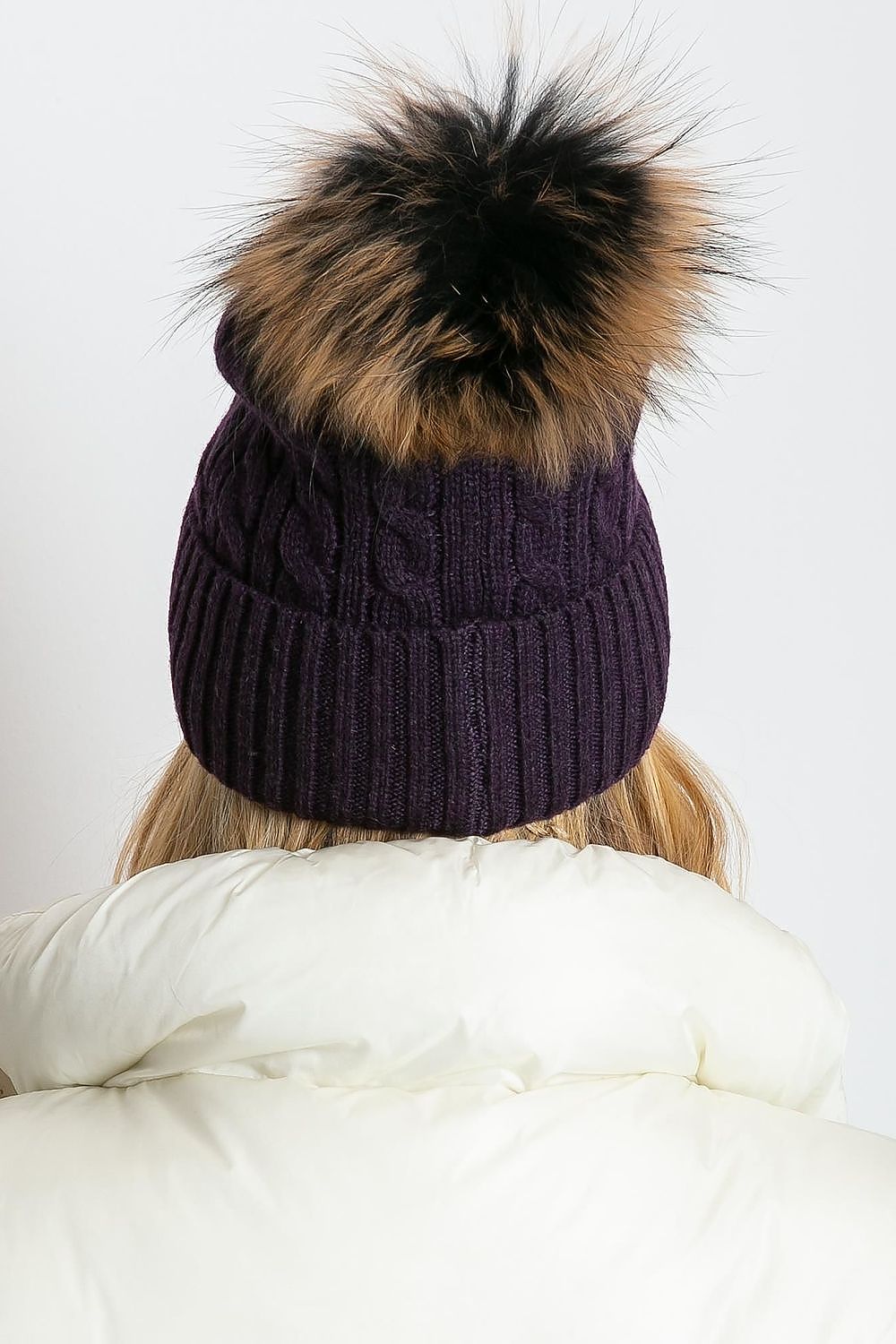 Elegant luxury winter cap by AT, featuring a wide cuff and fluffy pompom, crafted from a premium blend of 50% acrylic, 30% cotton, and 20% cashmere.