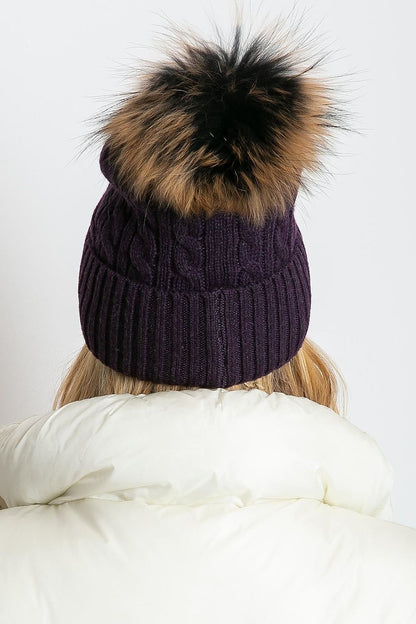 Elegant luxury winter cap by AT, featuring a wide cuff and fluffy pompom, crafted from a premium blend of 50% acrylic, 30% cotton, and 20% cashmere.