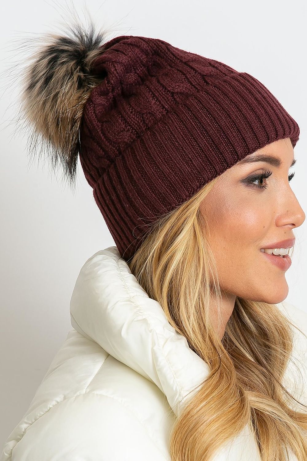 Chic luxury winter cap from AT, boasting a stylish wide cuff and soft fluffy pompom, designed with 50% acrylic, 30% cotton, and 20% cashmere for ultimate warmth.