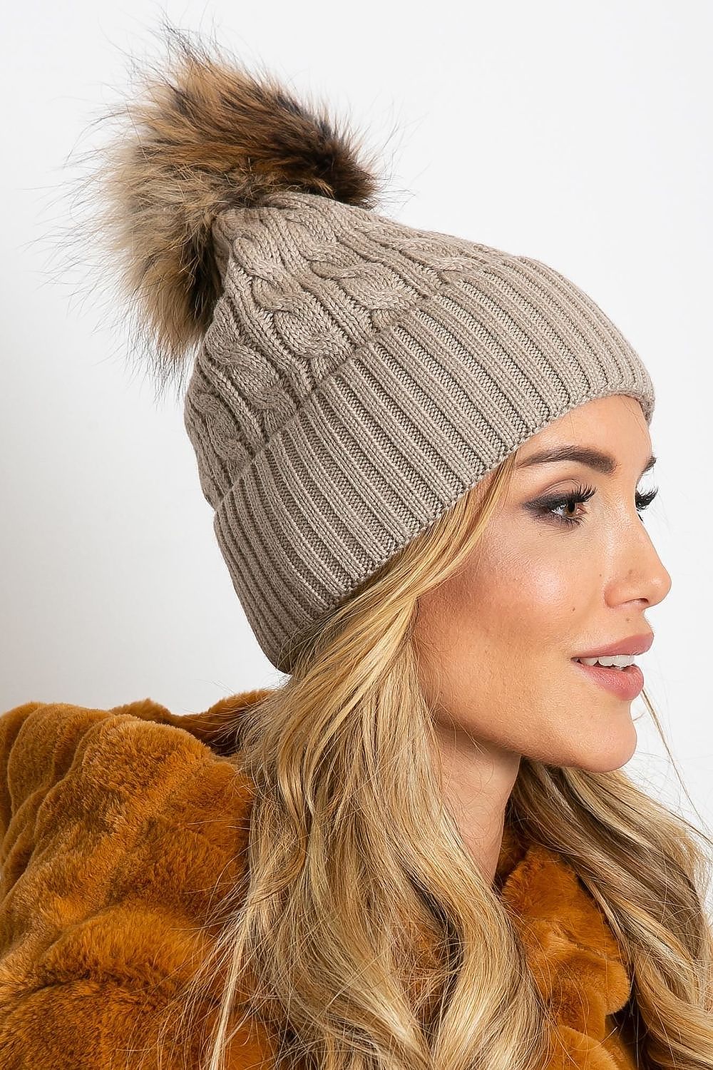 Stylish luxury winter hat by AT, embellished with a fluffy pompom and a wide cuff, fashioned from a rich blend of materials: 50% acrylic, 30% cotton, and 20% cashmere.