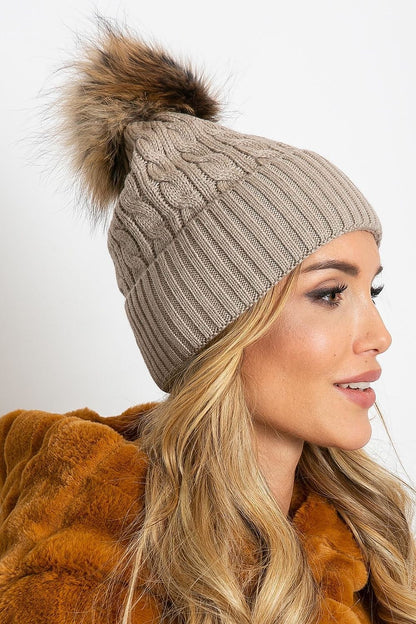 Stylish luxury winter hat by AT, embellished with a fluffy pompom and a wide cuff, fashioned from a rich blend of materials: 50% acrylic, 30% cotton, and 20% cashmere.