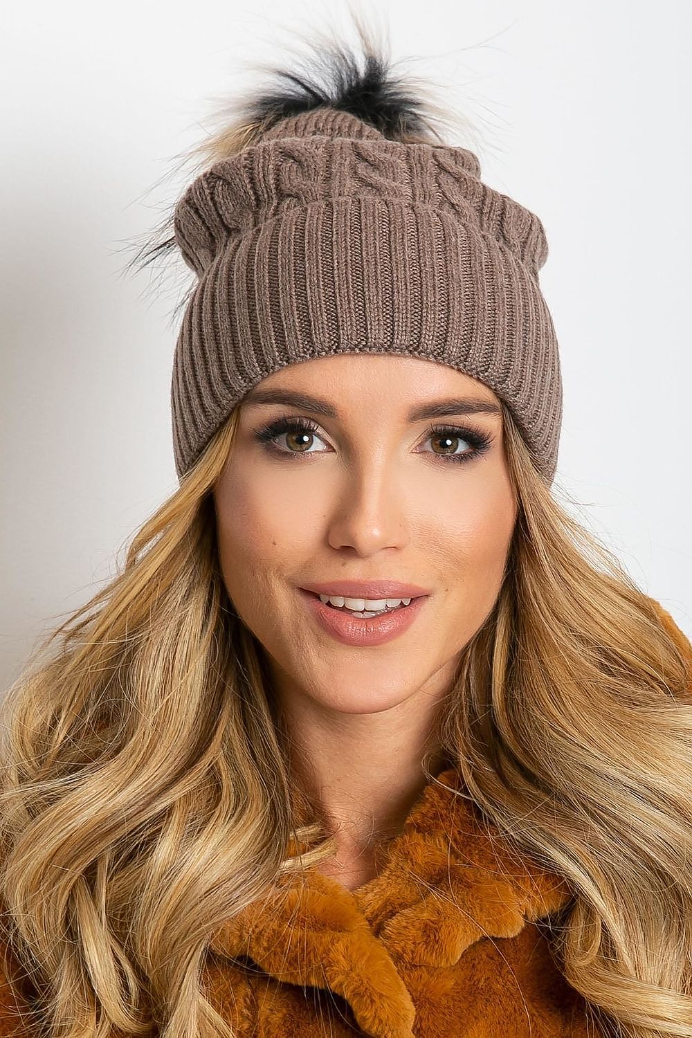 Elegant winter hat from AT, designed with a stylish wide cuff and soft fluffy pompom, made of high-quality materials including acrylic, cotton, and cashmere.