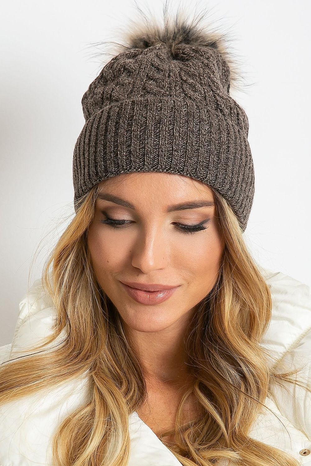 Stylish winter cap by AT, highlighting a wide cuff and a luxurious fluffy pompom, made from a soft blend of acrylic, cotton, and cashmere for ultimate comfort.