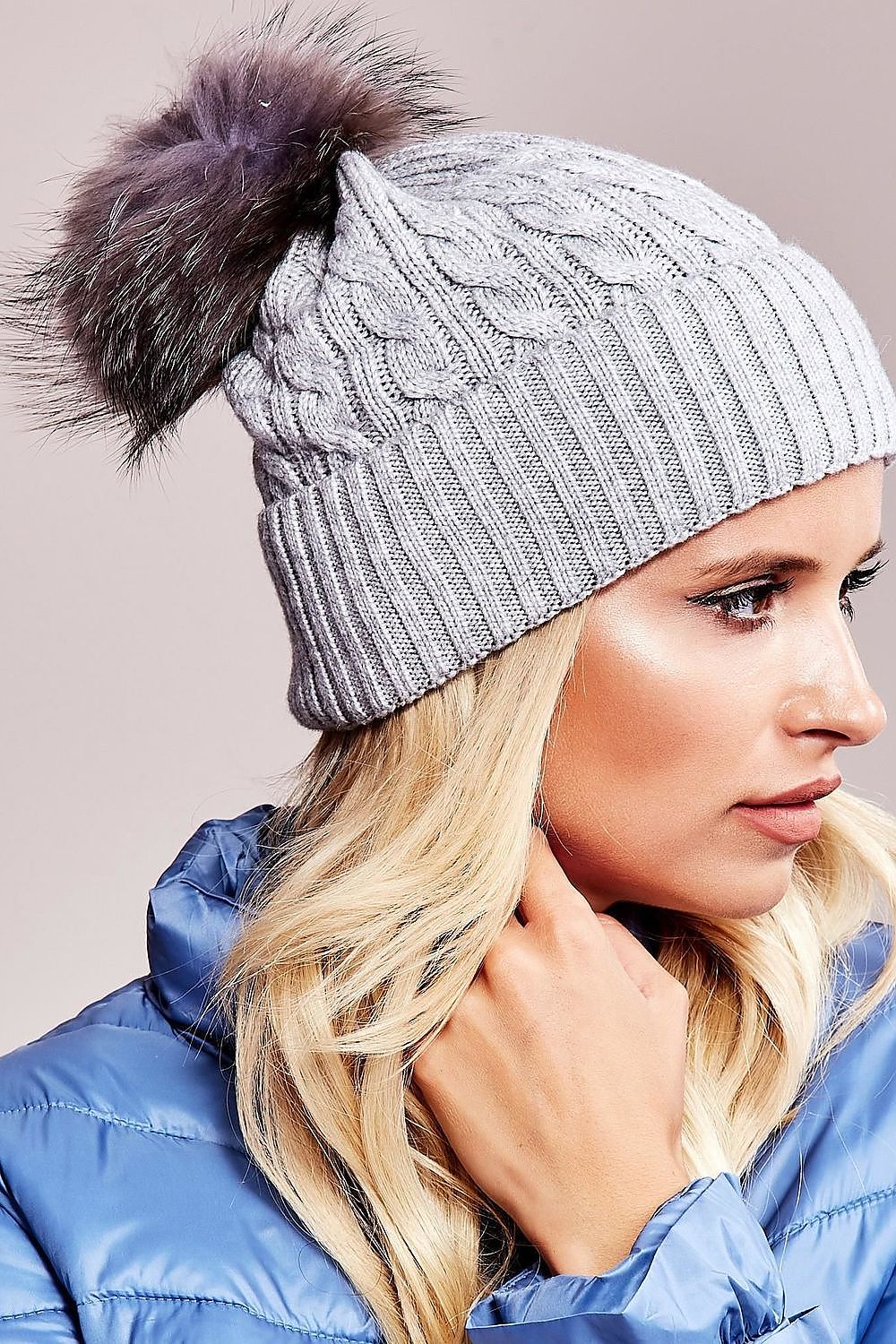 Sophisticated winter cap by AT with a luxe wide cuff and fluffy pompom, composed of 50% acrylic, 30% cotton, and 20% cashmere.