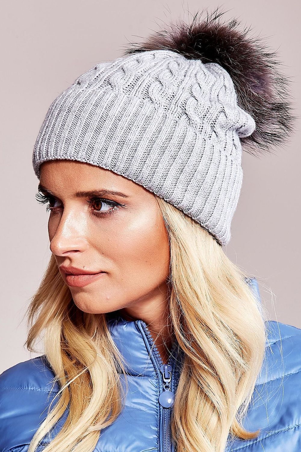 Exclusive winter hat by AT boasting a plush pompom and generous cuff, made from a luxurious blend of acrylic, cotton, and cashmere.