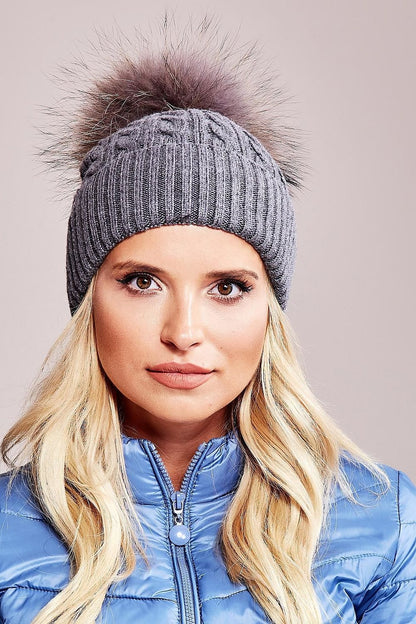 Elegant luxury winter cap from AT, featuring a wide cuff and fluffy pompom, crafted from 50% acrylic, 30% cotton, and 20% cashmere.