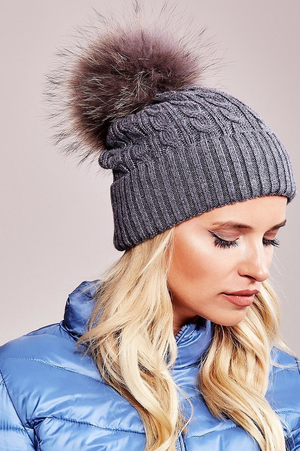 Stylish AT luxury winter hat with a soft fluffy pompom and wide cuff, made from a blend of acrylic, cotton, and cashmere for ultimate comfort.
