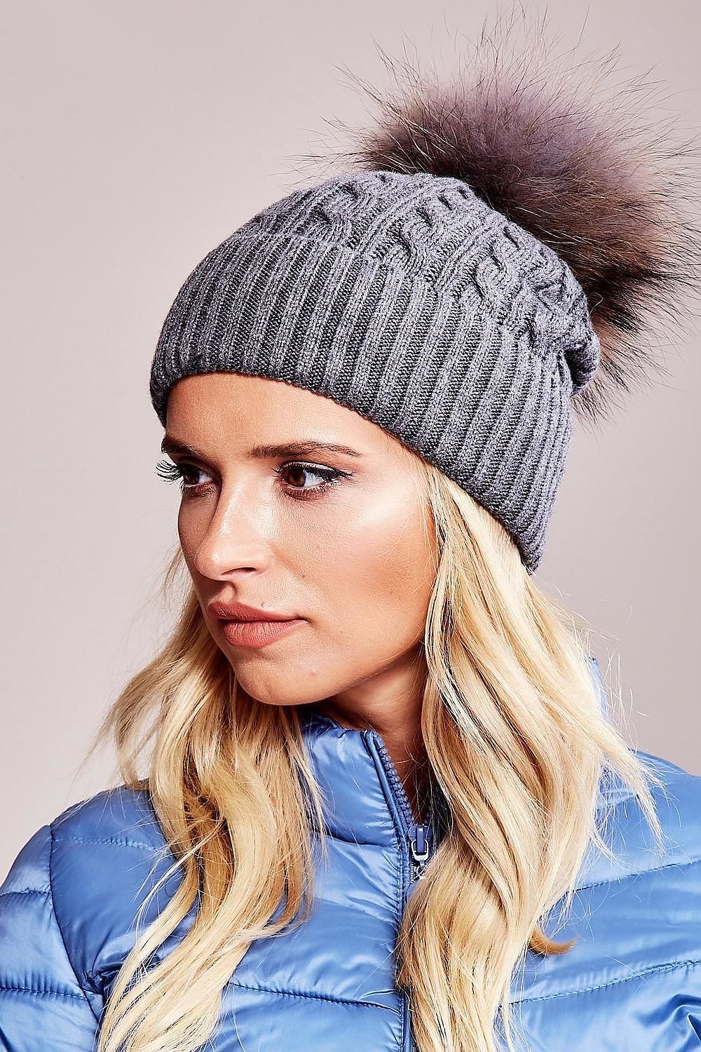 Chic winter cap by AT showcasing a luxurious fluffy pompom and wide cuff design, composed of high-quality materials: 50% acrylic, 30% cotton, and 20% cashmere.