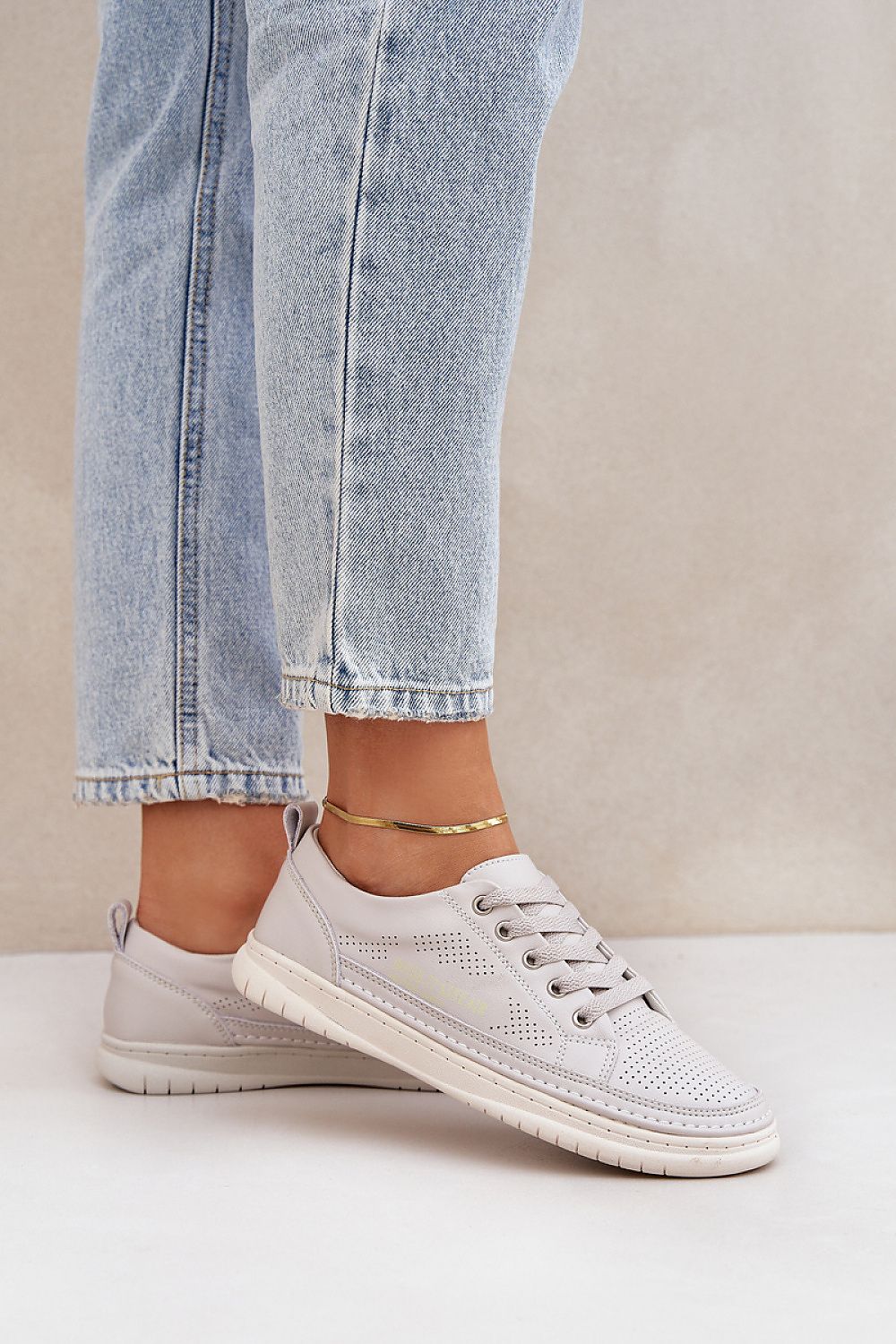 Luxury breathable leather sneakers for men and women by Step in Style, showcasing a classic low-top design with natural leather construction and perforations for comfort, ideal for everyday wear.