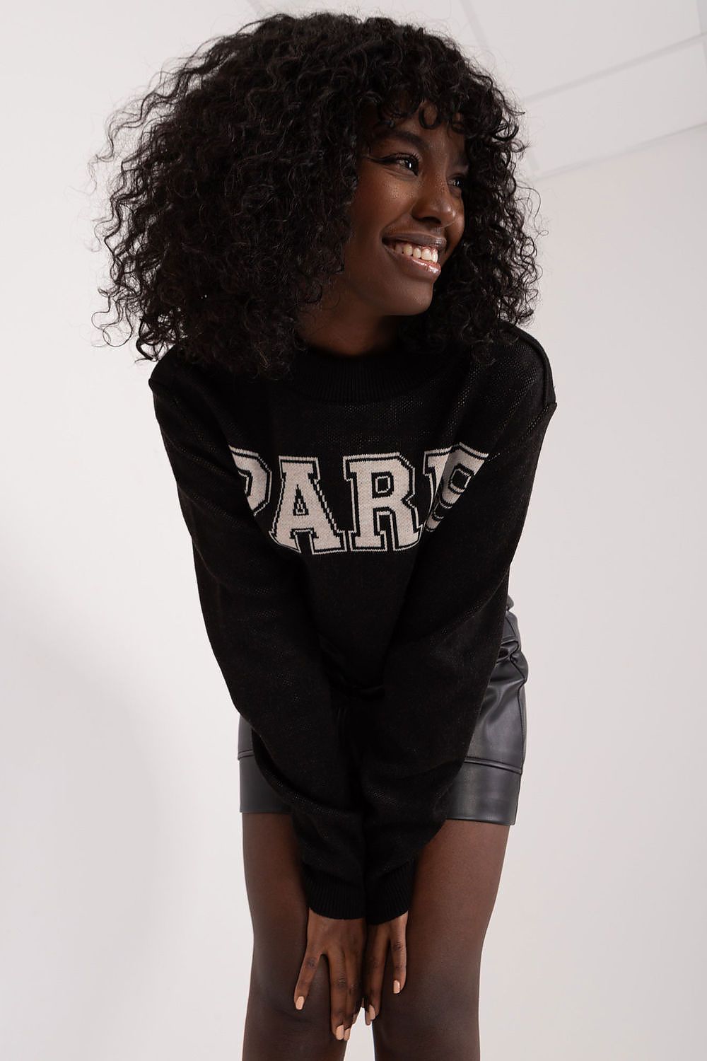 Trendy Badu women's casual jumper displayed on a model, styled with high-waisted pants, demonstrating its versatile fashion appeal.
