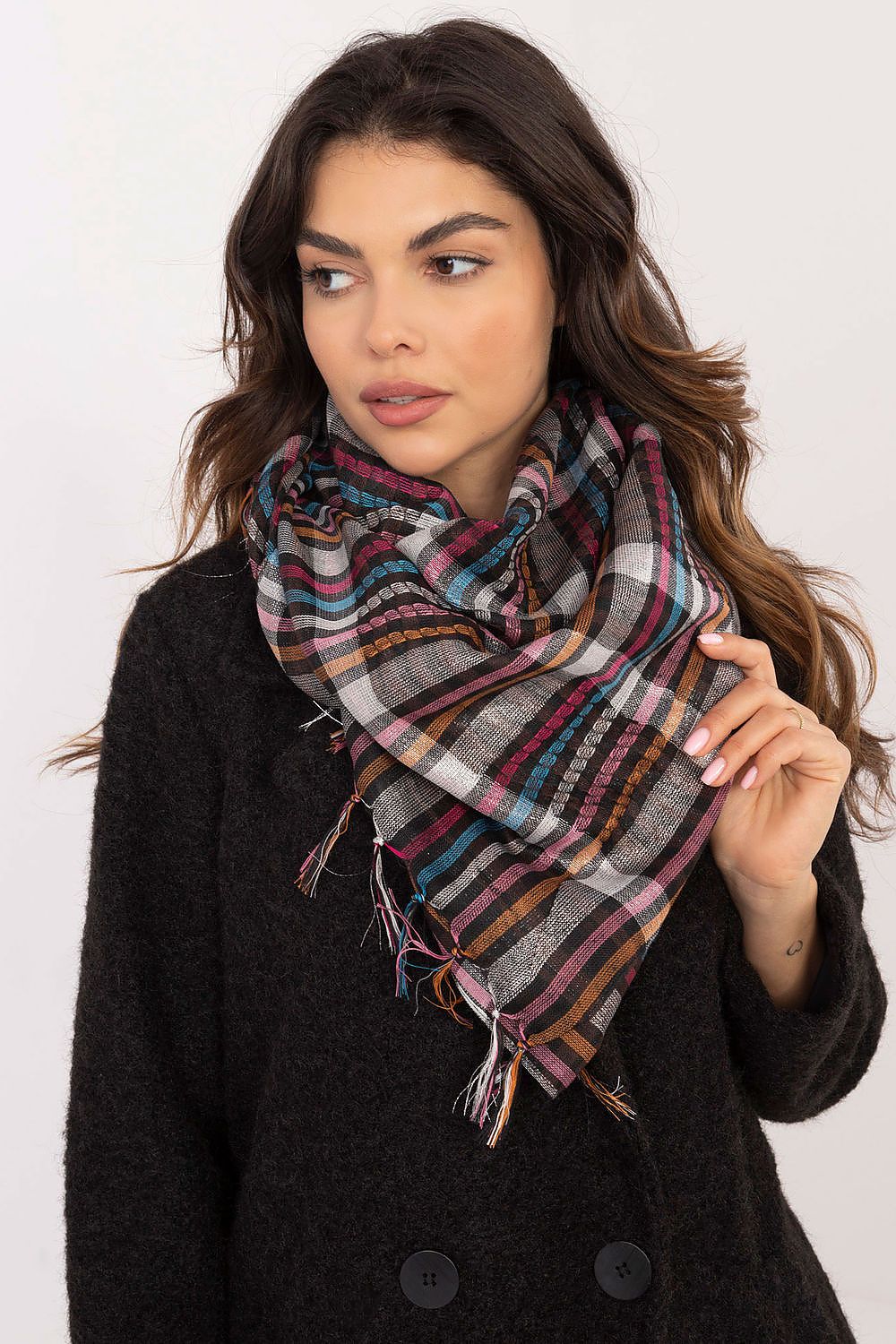 AT's fashionable checkered neckerchief scarf in a chic setting, highlighting its warm, soft texture and decorative fringes.
