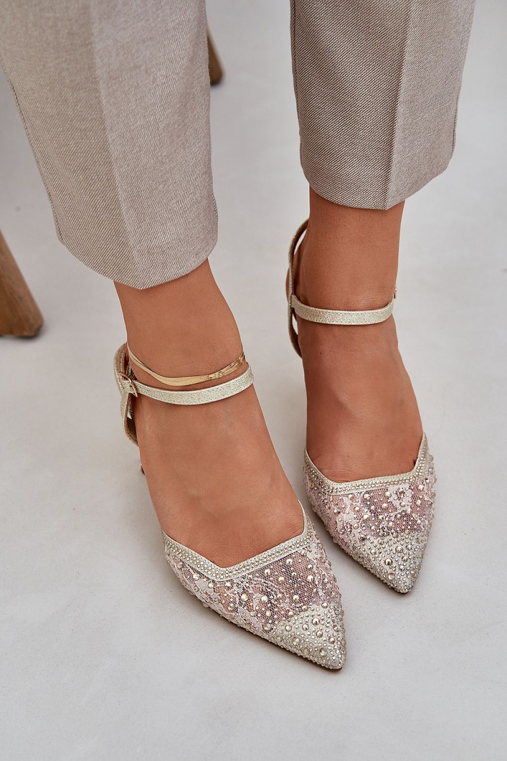 Close-up of luxurious shiny high heels with a sleek adjustable strap by Step in Style, showcasing refined elegance and comfort.