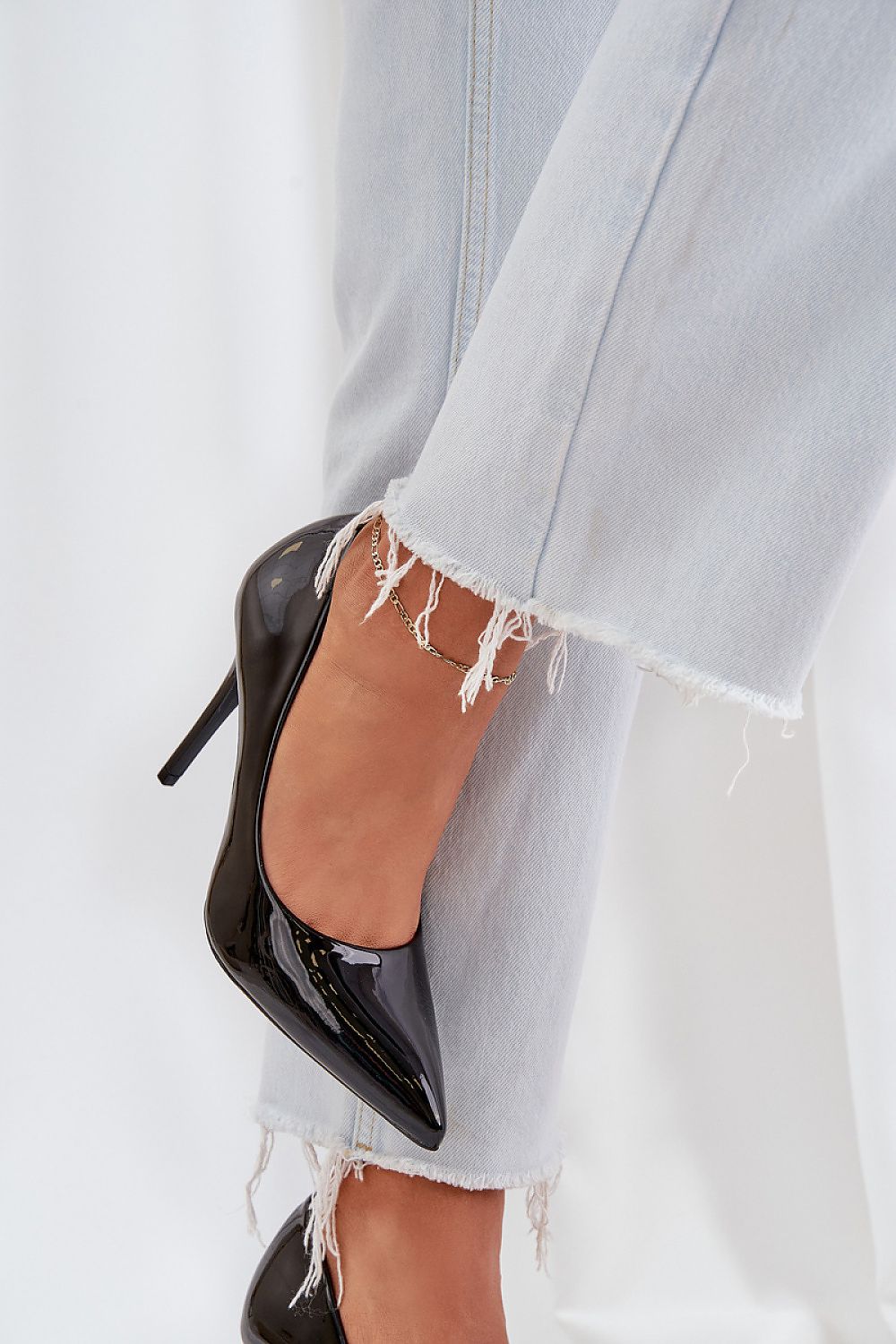 Stylish women's patent leather high heels displayed against a chic backdrop, emphasizing their elegance and versatility for formal occasions, crafted by 'Step in Style'.