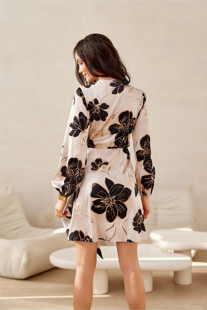 Elegant luxurious mini dress by Roco Fashion featuring long sleeves and a flattering wrap top design.