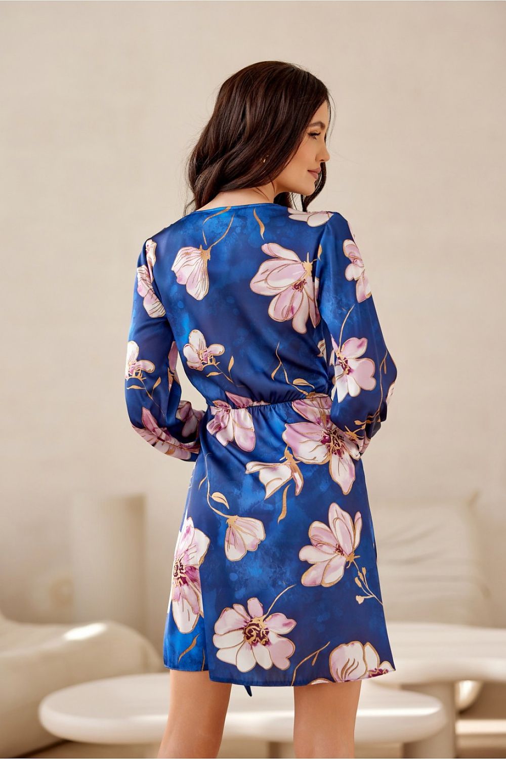 Model showcasing the sophisticated mini dress with long sleeves from Roco Fashion at a chic event.