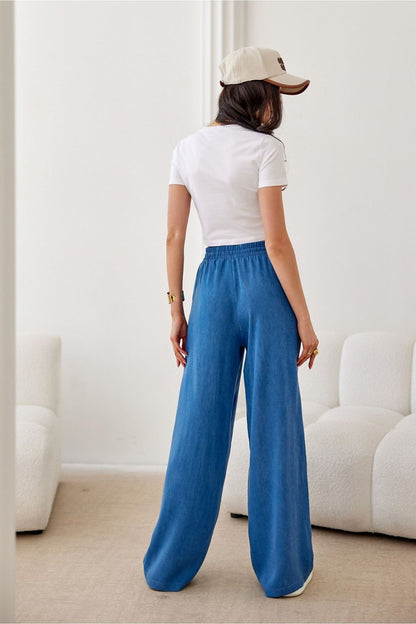 Stylish Roco Fashion women's trousers showcasing a tied top high waist and breathable fabric, designed for comfort and elegance.
