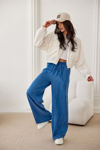 Elegant luxury women's trousers by Roco Fashion, featuring a high waist and wide leg design, shown in a stylish outfit suitable for chic casual or formal occasions.
